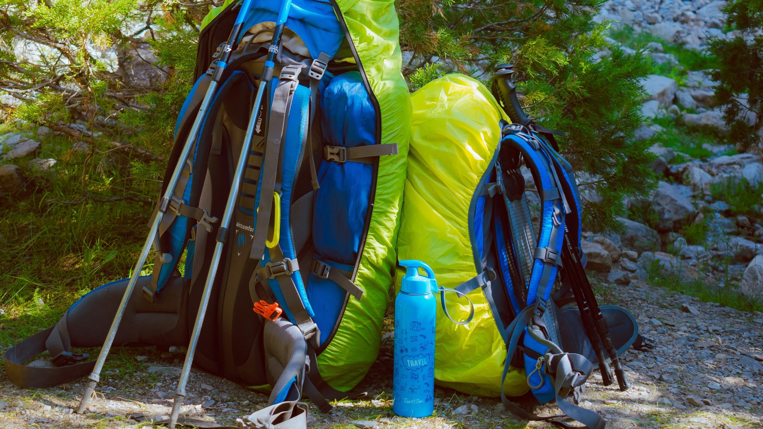 How to Build a Complete Camping Kit Without Breaking the Bank Two backpacks filled with affordable camping gear for building a complete camping kit on a budget